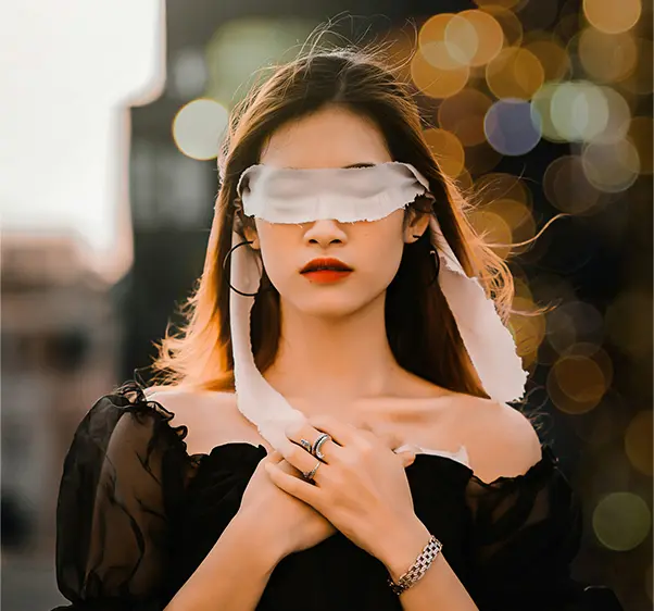 A woman blindfolded with a white scarf